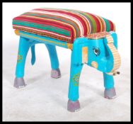 A brightly decorated piano stool / window seat in the form of an Elephant striped upholstered seat