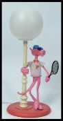 A vintage retro 20th century Pink Panther novelty lamp depicting the iconic character in sports wear