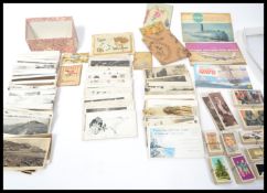 A collection of vintage postcards dating from the early 20th century together with a small