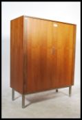 A large 1970's teak wood tambour fronted office filing cabinet. Raised on chrome legs with two