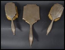 A silver hallmarked Art Deco dressing table set having a rising sun starburst engine turned