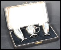 A George VI Art Deco silver cruet set, Birmingham 1934, makers mark 'Joseph Gloster Ltd', comprising