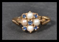 A hallmarked 9ct gold sapphire and seed pearl ring. Hallmarked Birmingham. Size P. Weight 3.1g.