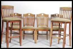 A set of four bistro style dining chairs having overstuffed seat pads together with a pair of