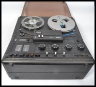 A vintage 20th century Philips Magno-Control N4512 reel to reel machine having a smokey plastic lid.