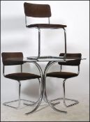 A mid 20th century gilt chromed tubular metal and smoked glass dining room suite comprising dining