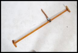 An early 20th century Doctor's surgery wooden wall mounted height measure complete with notation bar