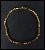 A hallmarked 18ct gold bracelet being set with white stones in a horse shoe link setting. Marked 18K