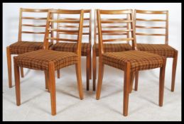 A set of six retro 20th Century teak dining chairs. Raised on tapering supports united by stretchers