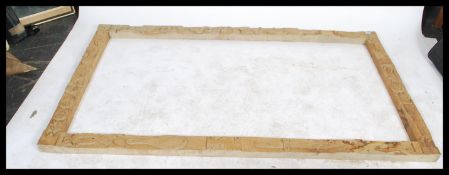 A large carved pine frame, the frame carved profusely with carvings of folk lore and nursery