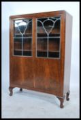 A 1930's Art Deco library bookcase cabinet with leaded glass bookcase cabinet over further