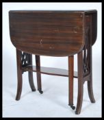An Edwardian solid mahogany sutherland table having lattice pierced supports with drop leaves