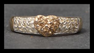 A hallmarked 9ct gold and diamond band ring having pave set diamonds to band and a champagne diamond