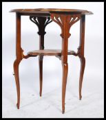 A 20th century Edwardian Arts and Crafts mahogany centre table raised on shaped supports united by a