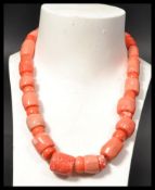 A large baroque coral necklace having varying coral beads of different sizes and form. Silver