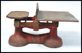 A vintage retro early 20th century W&T Avery Ltd set of balance scales having a painted red enamel