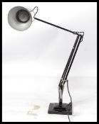 A 1940's Industrial pre-war Herbert Terry anglepoise lamp, raised on a cast metal two step base with