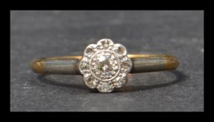 An 18ct gold diamond ring having a central illusion set diamond with a halo of diamond stones.
