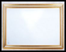 A large 20th century Antique style gilt wood mirror. The gilt frame with bevelled edge plate