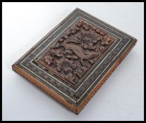 A 19th century Anglo Indian carved card case having micromosaic inlaid border with carved central
