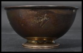 A silver hallmarked bowl of open cylindrical form raised on foot bearing hallmarks for A L Davenport