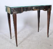 An Art Deco style 20th Century mirrored dressing table raised on sabre shaped legs drawer to the