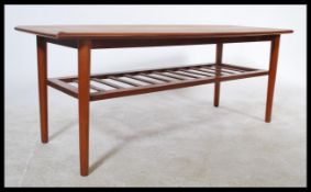 A mid century teak vintage / retro surf board style coffee table raised on tapered supports united