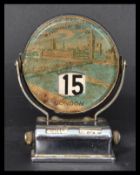 A vintage early 20th century tin perpetual flip desktop calendar with views of London depicting