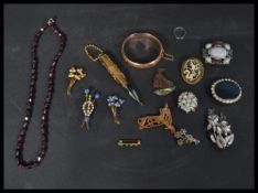 A group of vintage costume jewellery to include a yellow metal bangle bracelet , various