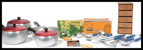 A set of four graduating retro aluminium saucepans with matching lids together with a boxed Spong