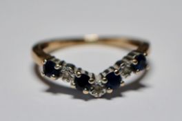A hallmarked 9ct gold sapphire and diamond wishbone ring having alternating illusion set diamonds