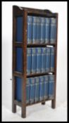 A set 1920's Dickens books housed within a wooden display shelf. Please see images.81x33x16