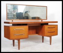 A 1970's G-Plan teak wood dressing table in the manner of Mogens Kolo. The dressing table raised