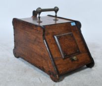 A 19th century oak fireside compendium coal box having carved details with brass handles. Complete