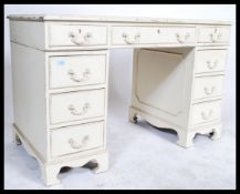 A shabby chic painted twin pedestal desk with leather inset top and fitted with nine drawers