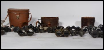A good collection of Binoculars dating from the early 20th Century to include military examples with