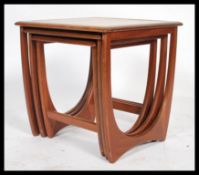 A 1970's retro teak wood Danish influence coffee table of lozenge shaped form raised on atomic /