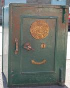 A vintage early 20th Century fire resistant green painted stainless steel safe, brass mechanism with
