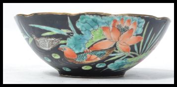 A 19th century Chinese hand painted bowl decorated with vibrant flowers and Asian Teal birds on a