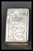 A 19th century Dutch silver white metal vinaigrette, in the form of a book, chased foliate scroll