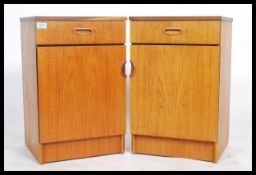 A pair of retro 1970's Danish influenced teak wood bedside cabinets chests. Each with locker door
