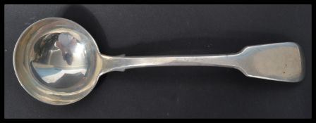 A hallmarked silver 19th century Georgian ladle in the fiddle pattern by Thomas Wallis (II) &