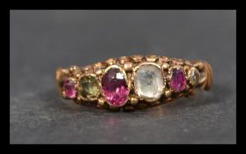 A Victorian hallmarked 15ct gold ring having multi coloured gemstones including ruby and rose cut