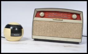 A vintage retro 20th century Bakelite Bush radio having a grille front with red tuning panel along