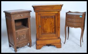 A 19th century solid oak French bedside cabinet with carved door and open recess together with