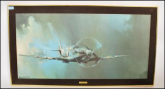 A framed and glazed print of a spitfire bearing notation to the mount by Barrie Clark. Measures: