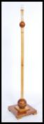 An early 20th Century Art Deco floor standing standard lamp, constructed from burr walnut and