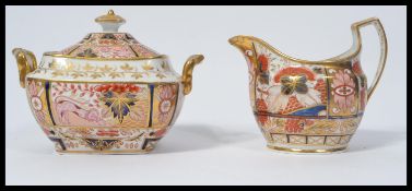 An early 19th century Coalport English Imari lidded sugar bowl and milk jug. Gilt detailed the sugar