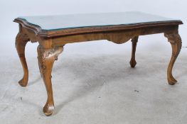 A good quality mid century walnut coffee table having a good shaped lozenge top with glass