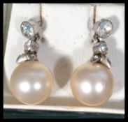 A good pair of vintage pearl and silver marcasite drop earrings having a large pearl with